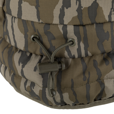Close-up of the Non-Typical Down Hat with Agion Active X2, showcasing camouflage ripstop fabric with baffles, draw-cord, and metal eyelets for adjustable fit.