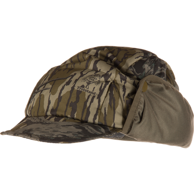 Camouflage-patterned Non-Typical Down Hat with Agion Active X2, featuring ear flaps, brim, and Mossy Oak logo, designed for warmth and comfort in harsh hunting conditions.