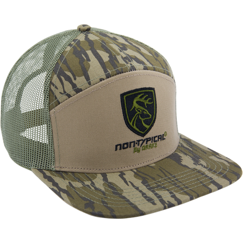 Camouflage-patterned trucker hat with green mesh back, tan front, camo brim, featuring a deer-head shield logo and non-typical® by ORYX, ideal for hunting enthusiasts.