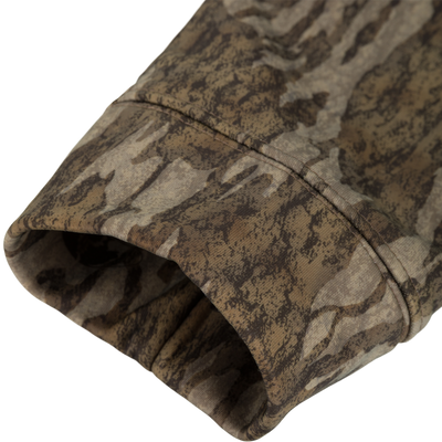 Close-up of Non-Typical Performance Hoodie with Scent Control, showcasing camouflage fabric, stitching, and tubular hood opening, highlighting its durability and style for hunting activities.