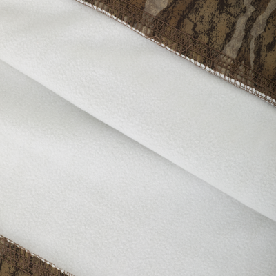 Close-up of the Non-Typical Performance Hoodie with Scent Control, showcasing its white fleece fabric and brown camouflage trim, highlighting its durable and stylish design for cold weather activities.