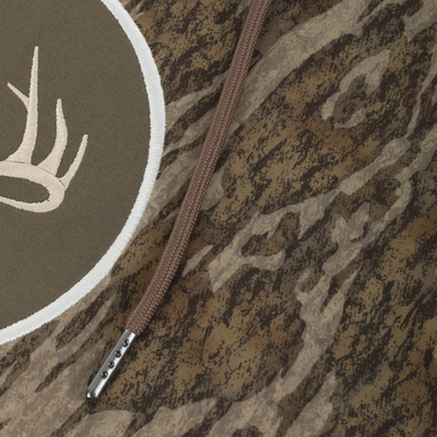 Non-Typical Performance Hoodie with Scent Control, featuring camo fabric, braided drawcord with metal aglet, and embroidered antler patch, ideal for cold weather hunting.