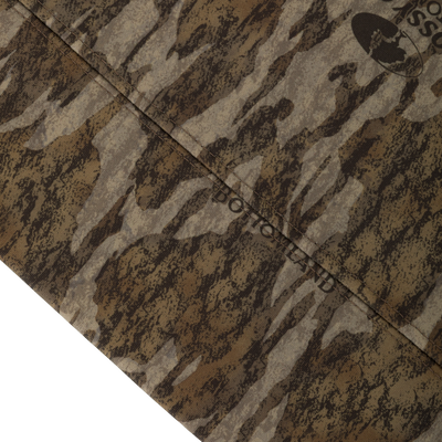 Close-up of the Non-Typical Performance Hoodie with Scent Control, showcasing a camouflage-patterned fabric with visible seam, emphasizing its durability and stretch for cold-weather activities.