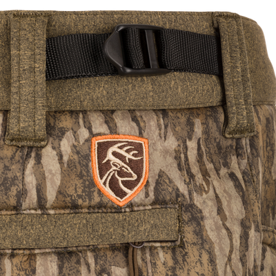 Close-up of Silencer Soft Shell Pant with Agion Active XL, featuring camouflage pattern, adjustable waist, and pockets. Ideal for quiet, comfortable hunting.