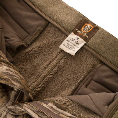 Close-up of the Silencer Soft Shell Pant with Agion Active XL, highlighting the adjustable waist and label detailing scent control technology.