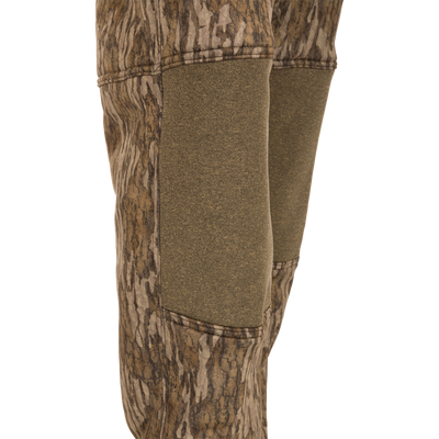 A pair of Silencer Soft Shell Pants with Agion Active XL, featuring camouflage design, adjustable waist, and pockets, designed for quiet hunting.