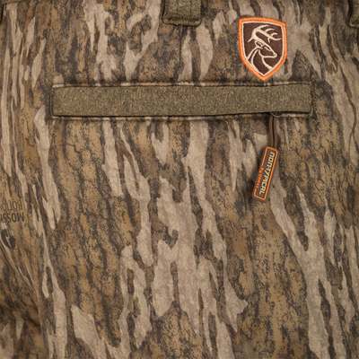 Close-up of Silencer Soft Shell Pant with Agion Active XL, showing camouflage design, adjustable waistband, and zipper details. Suitable for hunting with scent control technology.