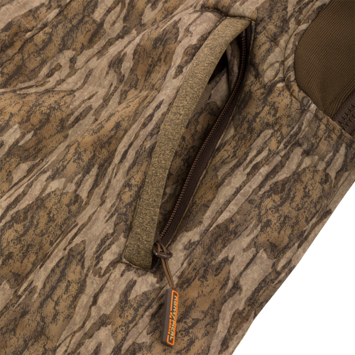 Close-up of the Silencer Bib's zipper, highlighting the durable exterior fabric and Sherpa fleece interior designed for warmth and scent control in hunting.