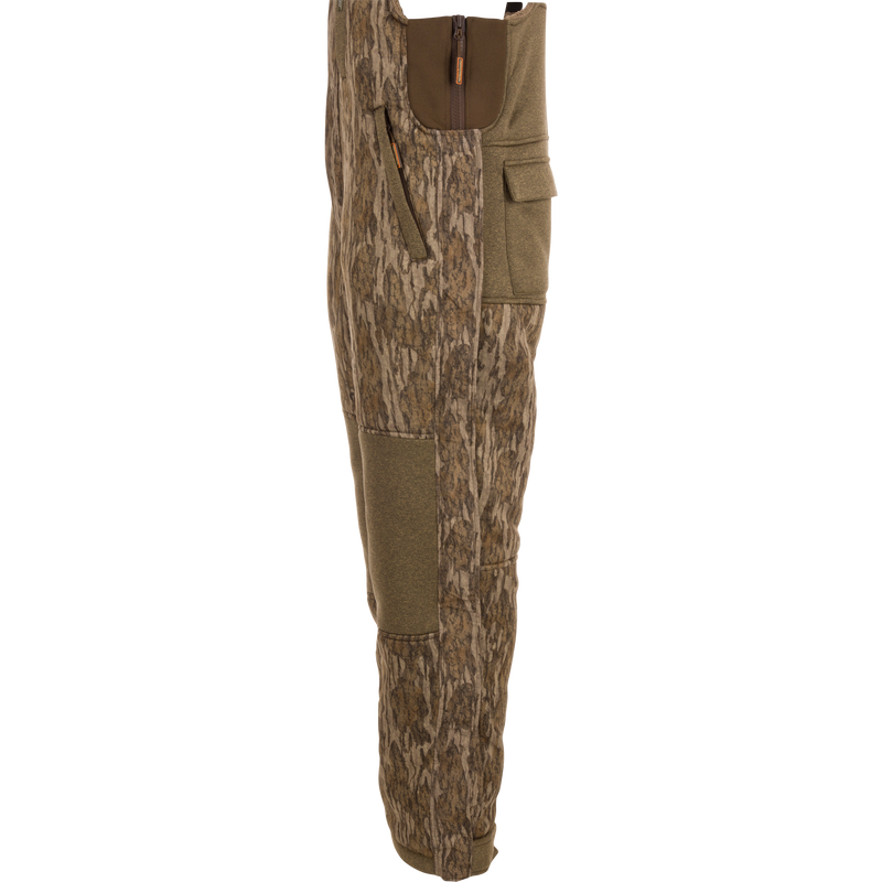 Silencer Bib with durable fabric, Sherpa fleece interior, vertical zippered chest pocket, and scent control technology for hunting.