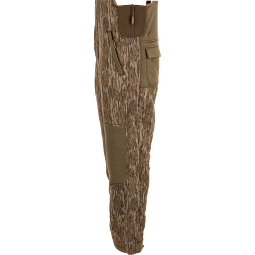 Silencer Bib with durable fabric, Sherpa fleece interior, vertical zippered chest pocket, and scent control technology for hunting.