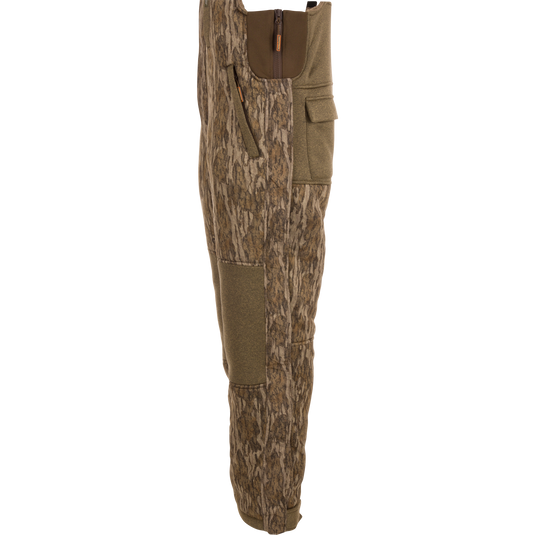 Silencer Bib with durable fabric, Sherpa fleece interior, vertical zippered chest pocket, and scent control technology for hunting.