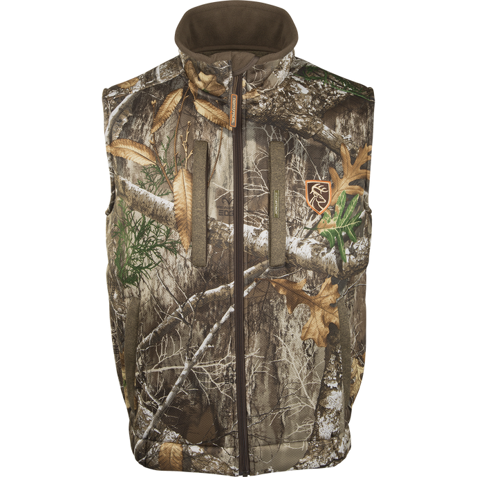 Silencer Vest with Agion Active XL, a camouflage patterned vest with leaves and a logo of a deer. Features vertical zippered chest pocket and lower zipped pockets.