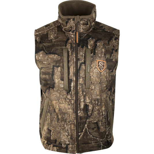 A Drake Silencer Vest with Agion Active XL, featuring a camouflage pattern and logo. Made of 100% polyester fabric with 400g fleece backing. Vertical and lower zippered pockets. Hunting gear from Drake Waterfowl.