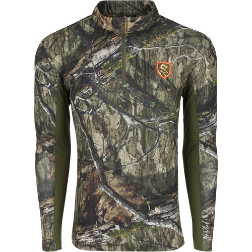 A long sleeved shirt with a camouflage pattern, featuring a logo of a deer.