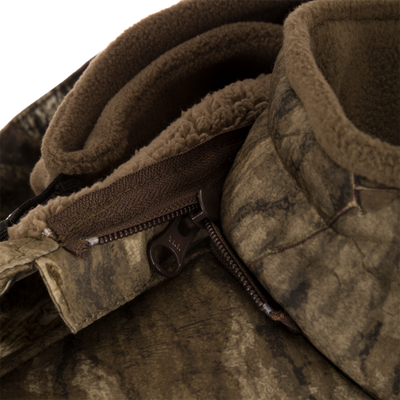 Close-up of the Stand Hunter's Silencer Jacket zipper, highlighting its durable, quiet fabric and advanced scent control technology for effective late-season hunting.