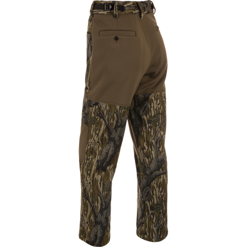 Non-Typical Endurance Pant with Scent Control, featuring olive-brown softshell top, tree-bark camouflage lower legs, reinforced knees, adjustable waist, and pockets for hunting versatility.