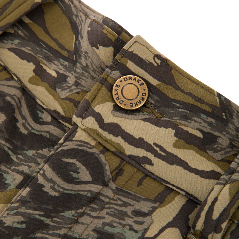 Close-up of the Non-Typical Endurance Pant, featuring a camouflage fabric pocket with a “DRAKE” snap button, designed for mid-season hunting with scent control technology.