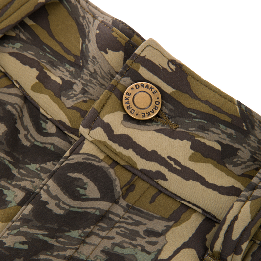 Close-up of the Non-Typical Endurance Pant, featuring a camouflage fabric pocket with a “DRAKE” snap button, designed for mid-season hunting with scent control technology.