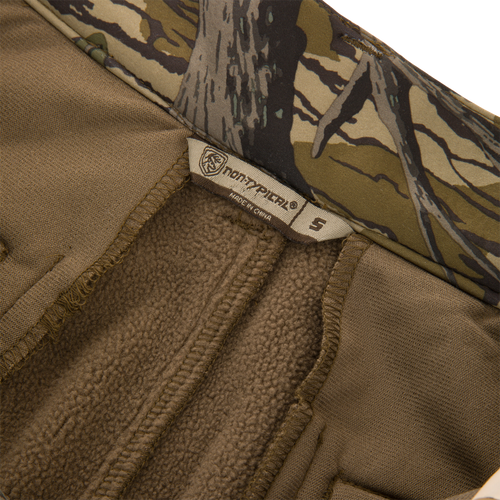 Close-up of the Non-Typical Endurance Pant with Scent Control, featuring soft brown fleece lining, camo trim, and Northfinder label, size S, for versatile hunting comfort.