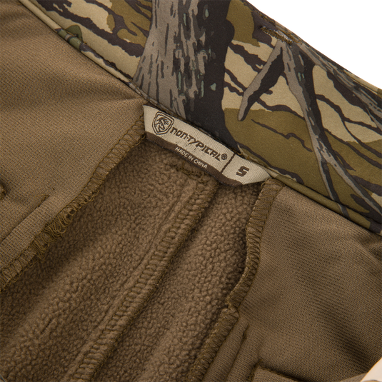 Close-up of the Non-Typical Endurance Pant with Scent Control, featuring soft brown fleece lining, camo trim, and Northfinder label, size S, for versatile hunting comfort.