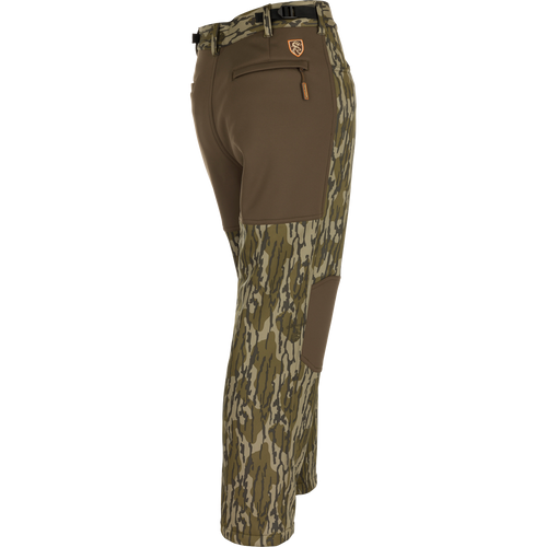 Youth Endurance Pant with camo pattern, solid brown stretch panels, built-in camo belt, zippered rear pocket, and reinforced knee patches, designed for active outdoor use.