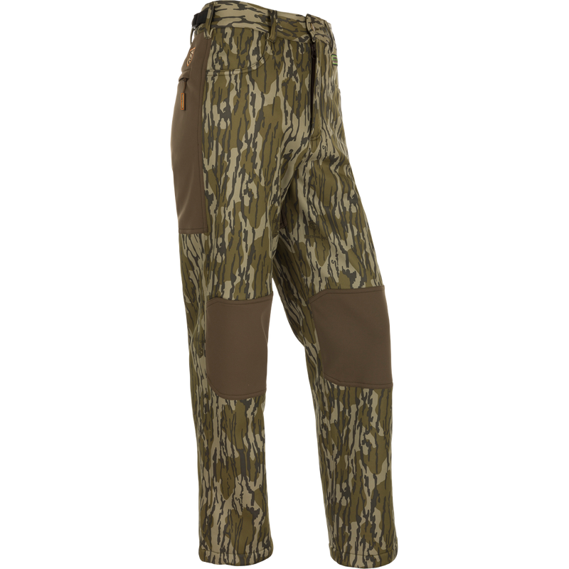 Youth Endurance Pant featuring camouflage design, reinforced knee patches, zippered side pocket, and adjustable waist, ideal for active youth in outdoor activities.