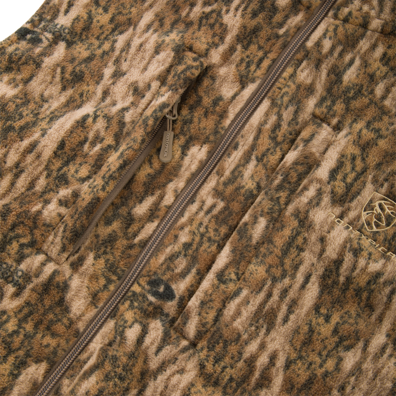 Non-Typical Windproof Layering Vest with zip-front, camouflage-style fleece, featuring a vertical zip pocket, patch pocket, and elastic-banded waist for outdoor protection.