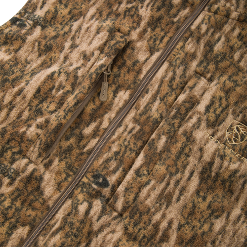 Non-Typical Windproof Layering Vest with zip-front, camouflage-style fleece, featuring a vertical zip pocket, patch pocket, and elastic-banded waist for outdoor protection.