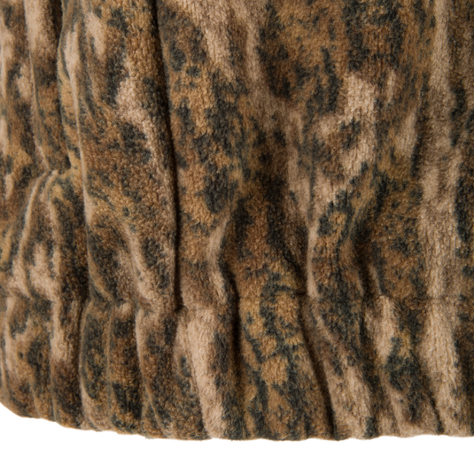 Close-up of the Non-Typical Windproof Layering Vest's elasticized hem, showcasing its plush, textured sherpa-style fleece fabric designed for warmth and outdoor durability.