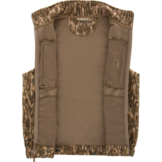 Non-Typical Windproof Layering Vest with a camouflage fleece shell, tan lining, and built-in mesh pockets, ideal for hunting and outdoor activities.