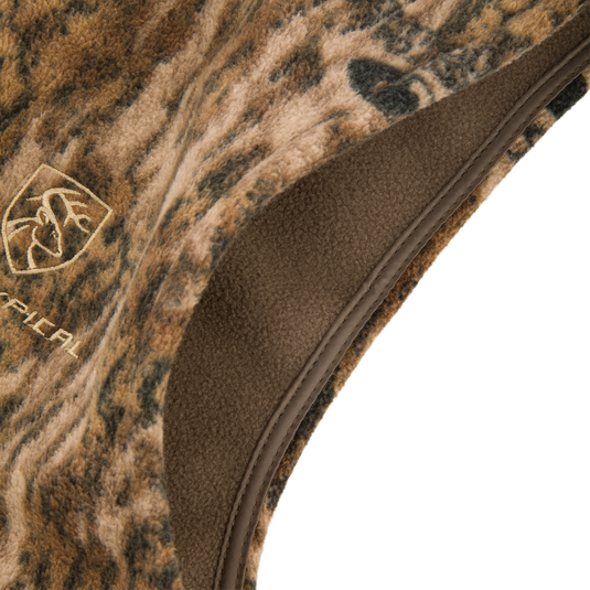 Camo-patterned, fleece-lined bucket hat with embroidered deer-antler logo, designed for outdoor comfort, complements the Non-Typical Windproof Layering Vest by Drake Waterfowl.