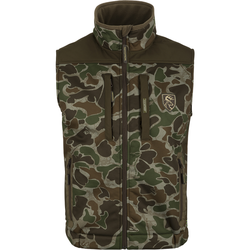 A camouflage Standstill Windproof Vest with Agion Active XL®, perfect for mid-to-late season hunting. Layer underneath or wear over a mid-layer for added warmth. Features vertical zippered chest pockets, lower zippered security pockets, and a safety harness pass-through opening.