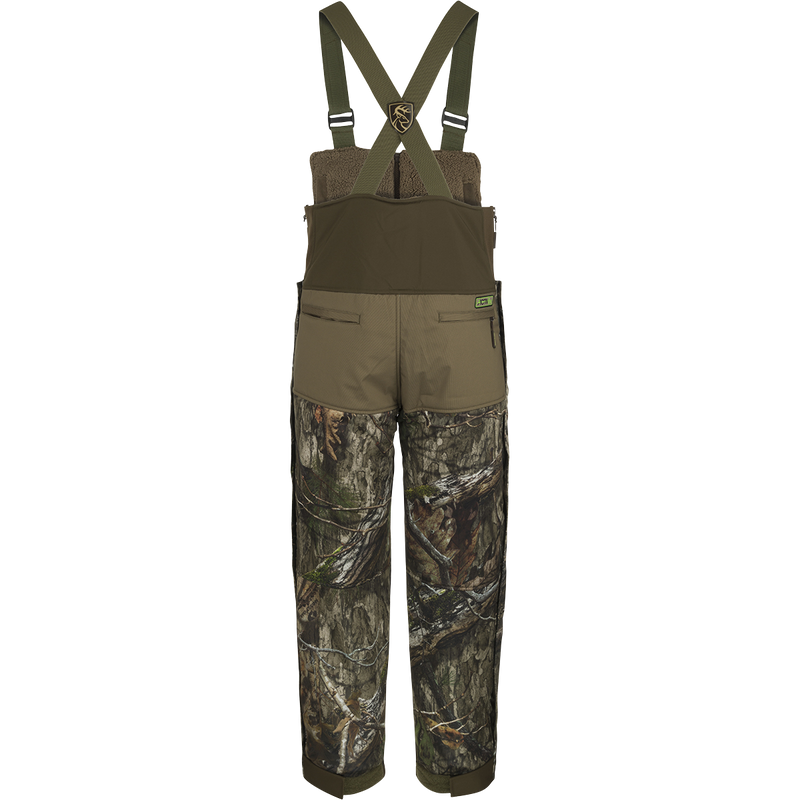 A pair of Standstill Windproof Bib with Agion Active XL® heavy-weight bib pants, perfect for late-season hunting. Made with durable fabric and featuring scent control technology, chest pockets, handwarmer pockets, and lower security pockets. Ideal for harsh cold and winds.