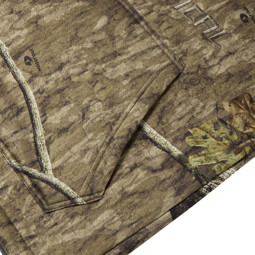 Non-Typical Silencer Hoodie with Agion Active X2, featuring Mossy Oak camo pattern, visible kangaroo pocket stitching, designed for warmth, breathability, and odor protection.