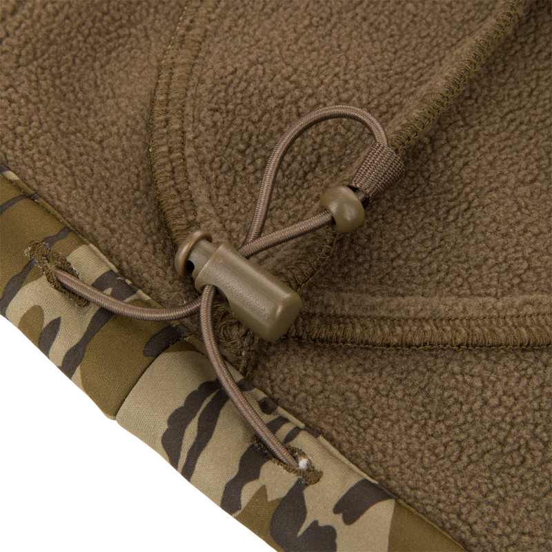 Close-up of the Non-Typical Endurance Hooded Full Zip Jacket's adjustable drawcord and cord-lock, highlighting its camo-patterned edge designed for hunting comfort.