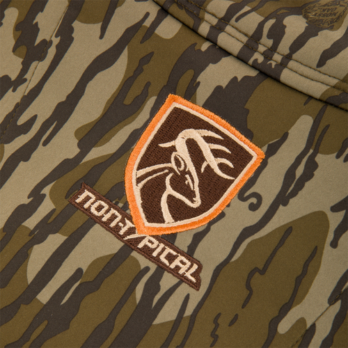 Close-up of Non-Typical Endurance Hooded Full Zip Jacket with Scent Control, featuring a camouflage pattern and shield-shaped NANHI PIPAL patch with stylized deer head.