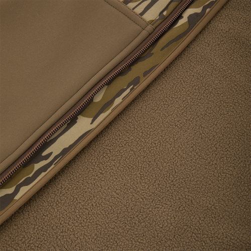 Non-Typical Endurance Hooded Full Zip Jacket with Scent Control, featuring a camouflage-print trim zipper and fleece lower section, designed for hunting comfort and protection.