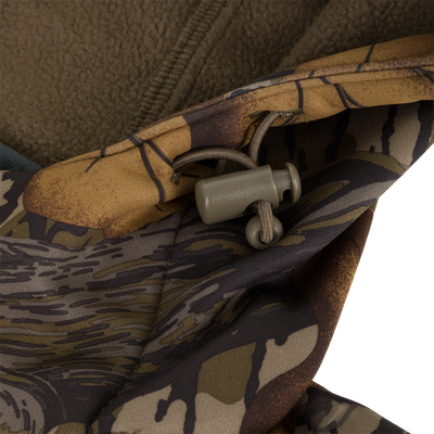 Close-up of a Non-Typical Endurance Hooded Full Zip Jacket with Scent Control, featuring a camouflage pattern and an adjustable drawstring cord lock at the neck.