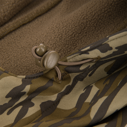 Youth Endurance Full Zip Jacket with Hood featuring camo pattern, brown fleece lining, elastic draw-cord hem, and plastic toggle for adjustable fit.