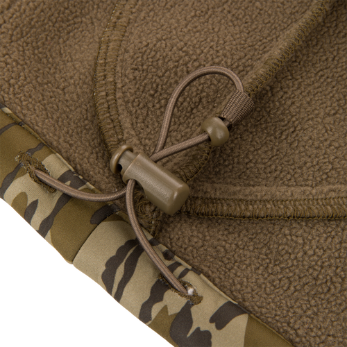 Close-up of Youth Endurance Full Zip Jacket with Hood, showing brown fleece hem with camouflage trim and elastic drawcord, highlighting durability for hunting activities.