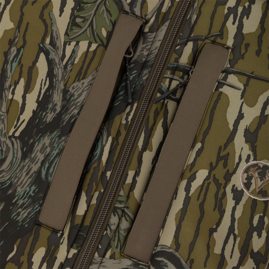 Close-up of a camouflaged Nontypical Youth Endurance Full Zip Jacket with Hood, featuring a central zipper and two vertical zippered pockets.