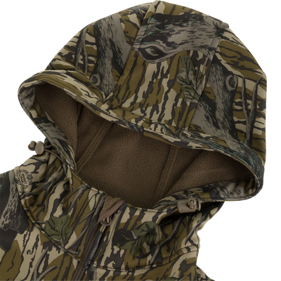 Nontypical Youth Endurance Full Zip Jacket with Hood in a tree-bark camouflage pattern, featuring a drawstring hood and a brown fleece lining with integrated scent control technology.