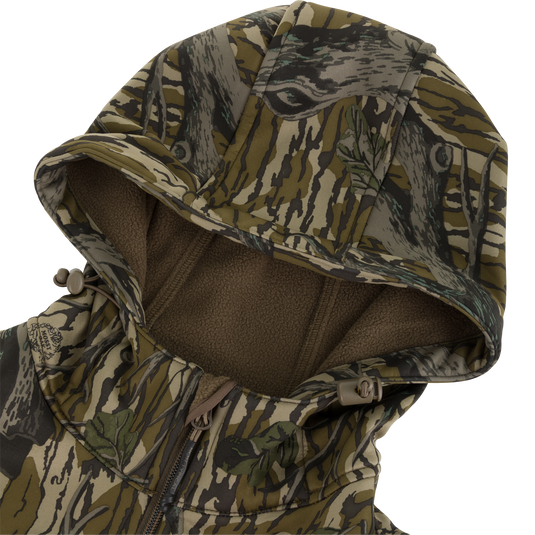 Nontypical Youth Endurance Full Zip Jacket with Hood in a tree-bark camouflage pattern, featuring a drawstring hood and a brown fleece lining with integrated scent control technology.
