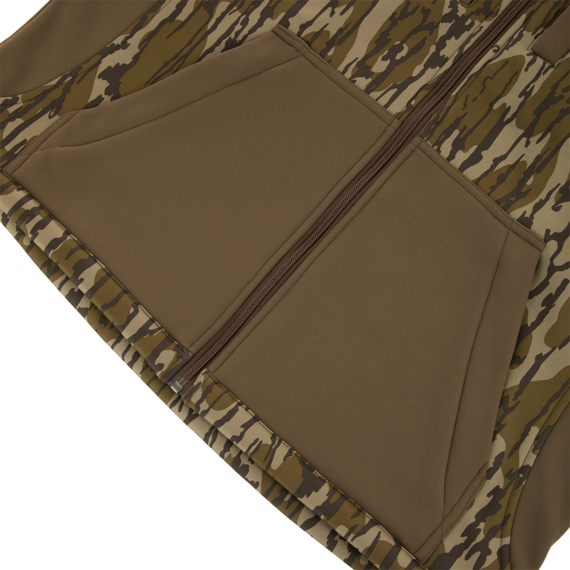 Youth Endurance Full Zip Jacket with Hood features a camo print, central zipper, and angled kangaroo-style pockets, ideal for outdoor activities with scent control technology.