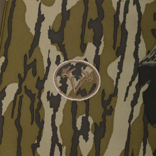 Embroidered circular logo featuring a deer antler design on a camouflage Nontypical Youth Endurance Full Zip Jacket with Hood.