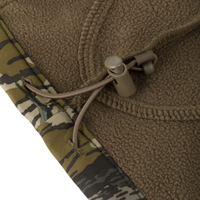Close-up of a brown microfiber stretch hood with a drawstring toggle on a Youth Endurance Full Zip Jacket with Hood.