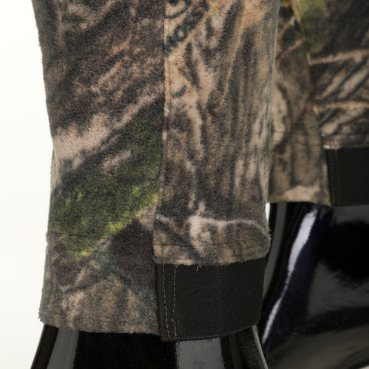 A close-up of the Storm Front Fleece Midweight 4-Way Stretch Pant, featuring a camouflage pattern and black fabric.