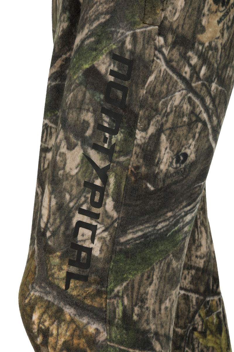 A close-up of the Storm Front Fleece Midweight 4-Way Stretch Pant, featuring camouflage fabric and a logo.