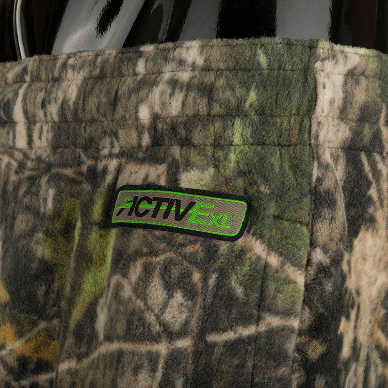 A close-up of the Storm Front Fleece Midweight 4-Way Stretch Pant, featuring camouflage pattern and a patch.