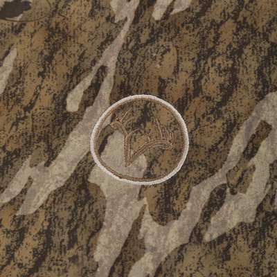 Close-up of the Non-Typical Silencer Sherpa Fleece Neck Gaiter featuring a camo pattern with an embroidered scorpion patch, designed for warmth and scent control.